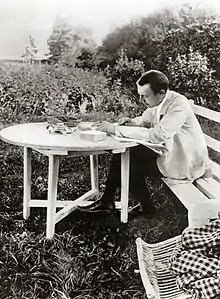 Sergei Rachmaninoff at Ivanovka, proofing his third piano concerto.