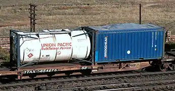 A spine car with a 20 ft tanktainer and an open-top 20 ft container with canvas cover