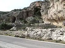 Raised beach 2 km west of Paleochora (Crete) showing wave-cut notch and sea caves uplifted by about 9 m during the earthquake