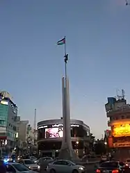 Monument and Palestinian flag at Al Sa’a Square/Yasser Arafat Square in Ramallah