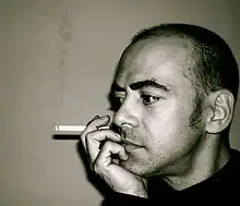 Black-and-white photo of Unzueta with a cigarette