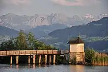 The wooden bridge, as seen from nearby Seedamm, Obersee and Wägital in the background