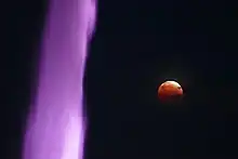 Red moon from a lunar eclipse with the fountain in the foreground