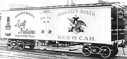 Photograph of an early refrigerated railroad car with Anheuser-Busch beer advertisements