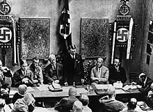 Image 12Adolf Hitler (standing) delivers a speech in February 1925 (from 1920s)