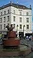 The granite fountain "Fugl med Guldæble" (Bird with Golden Apple) and the Regina building in the background