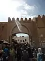 Passengers and merchants at the entrance of the medina