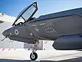 A F-35I Adir of 117th Squadron "First Jet" (jet-in-the-crosshairs symbol) at the reopening