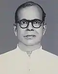 Bespectacled priest in white