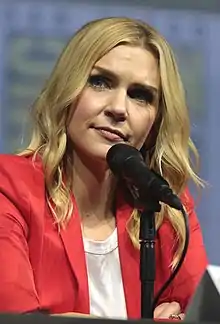 Seehorn seated at a microphone