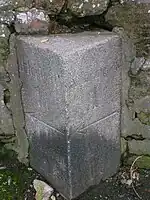 A milestone at the lazy corner near the parish kirk with directions to Kilmarnock, Hurlford, Galston and Ayr.