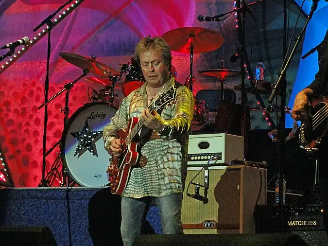 Derringer playing guitar onstage