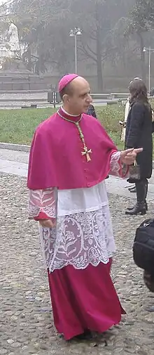 His Excellency Monsignor Rino Fisichella wearing a rochet with lace.