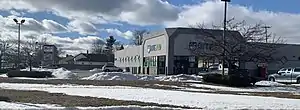 An exterior view of a Rite Aid drugstore and its parking lot.