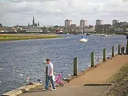 The river Irvine at the harbour with the town in the background.