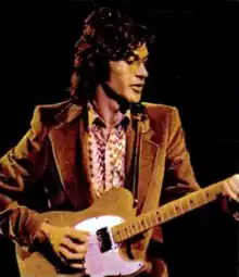 A man playing an electric guitar