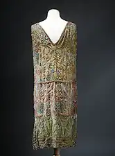 Art Deco dress decorated with lotus flower that are inspired by those found in Ancient Egyptian decoration, by Jenny (couturier) and Lesage (embroiderer), 1926, silk, metallic thread, and crocheted embroidery, Musée Galliera, Paris