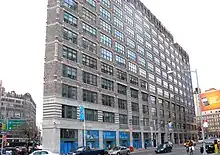 Building facade with interior window treatments reading "The Jackie Robinson Museum"