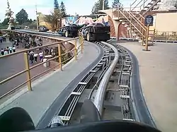 Rocket Rods leaving the loading platform. Vehicles paused before being flung down the track at high velocity and then slowing down to make the sharp corner toward the end.