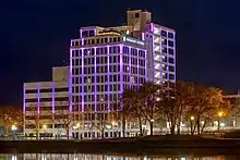 A photo of a brightly and colorfully lit renovated hotel near the Rock River in Rockford, Illinois. This use to be the Ziock building