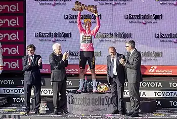 Primož Roglič receiving the winner's trophy