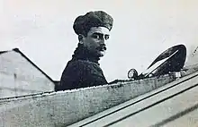 Roland Garros in open cockpit of aircraft, looking at viewer