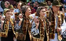 A group of teens are wearing a Romanian traditional clothes