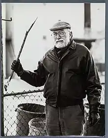 man standing outside, wearing coat and hat