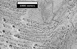 Rootless Cones, as seen by HiRISE.  The chains of rings are interpreted to be caused by crust moving over a source of steam.  The steam was produced by lava interacting with water ice.