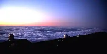 Telescopes at the observatory at sunset, from left to right: the NOT, the WHT, the DOT, the SST, the Mercator Telescope and the ING