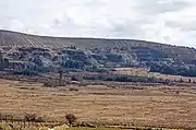 heathland with quarries beyond and mountain behind