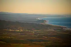 An aerial photograph of Ross, with the Tasman Sea seen to the right