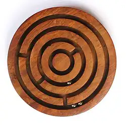 Image 16A ball-in-a-maze puzzle (from List of wooden toys)