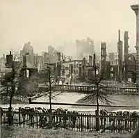 Smoke is still rising from the ruins of Richmond, Virginia after surrendering on April 3, 1865 following the Union victory at the siege of Petersburg. Union cavalry mounts with carbines visible are hitched in the foreground.