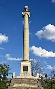 A tall fluted granite Ionic column topped with a stone globe.