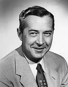 Portrait photo of Russ Bogda wearing a suit and tie