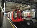 A District line S7 Stock train standing at bay platform 3 for shuttle route to Olympia.