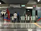 Commuters using the fare gates leading to Entrance B of the station.