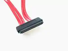 Four red cables lead into a wide black electrical connector