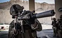 Belgian SFG soldier armed with the SCAR-L with a suppressor