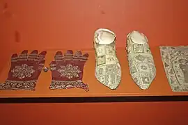 Silk liturgical gloves (left) of Cardinal Pierre de Foix (15th century), dyed crimson with P. hamelii carmine