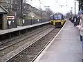 Two Class 333 trains cross at the station.