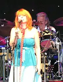 Brown singing into a microphone onstage