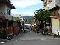 Street in Poblacion Sampaloc with the Sierra Madre mountains in the background