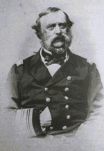 photo portrait of a mustashioed U.S.N. officer seated in uniform