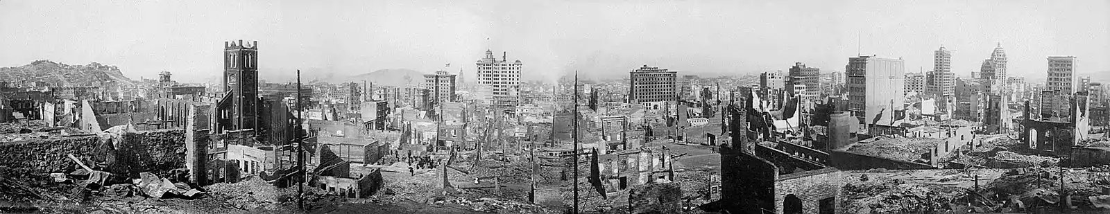 Black-and-white photograph of a city with numerous buildings in ruins