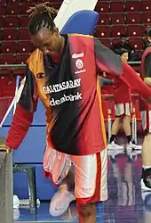 Woman bending forward wearing jersey from Galatasaray