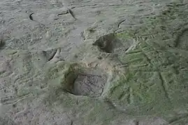 Gaps in the surface of the stone indicate where symbols have been excised