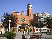 Main façade of the Parish Church of Sant Adrià and the square named after the church where it is situated.