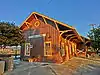 A wooden railroad station building